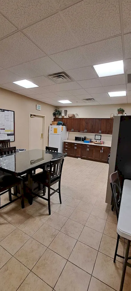 Completed commercial breakroom with kitchenette finishes and updated interior details